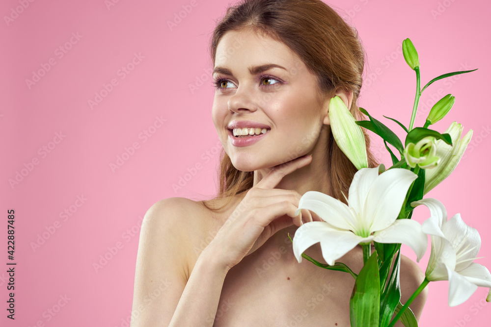 Beautiful woman with flowers on pink background makeup portrait model Beautiful woman with flowers on pink background makeup portrait model