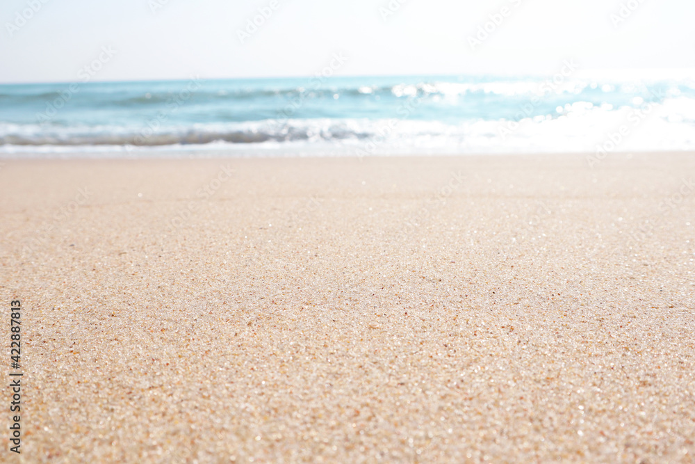 Summer Vacation and Travel Holiday or brander Concept : beautiful seascape view of sand beach and blurred blue sea with sky in background.Selective focus can be use for the background