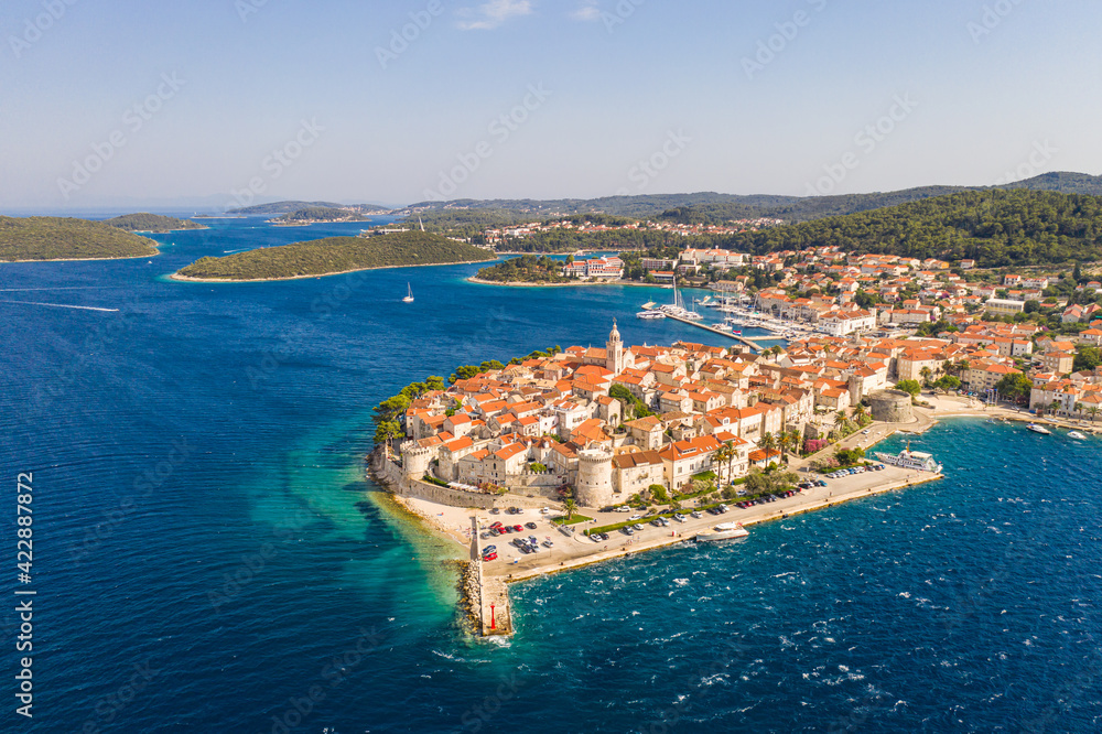 Dramatic aerial view of the Korcula medieval old town by the Adriatic sea on a sunny summer day in Croatia