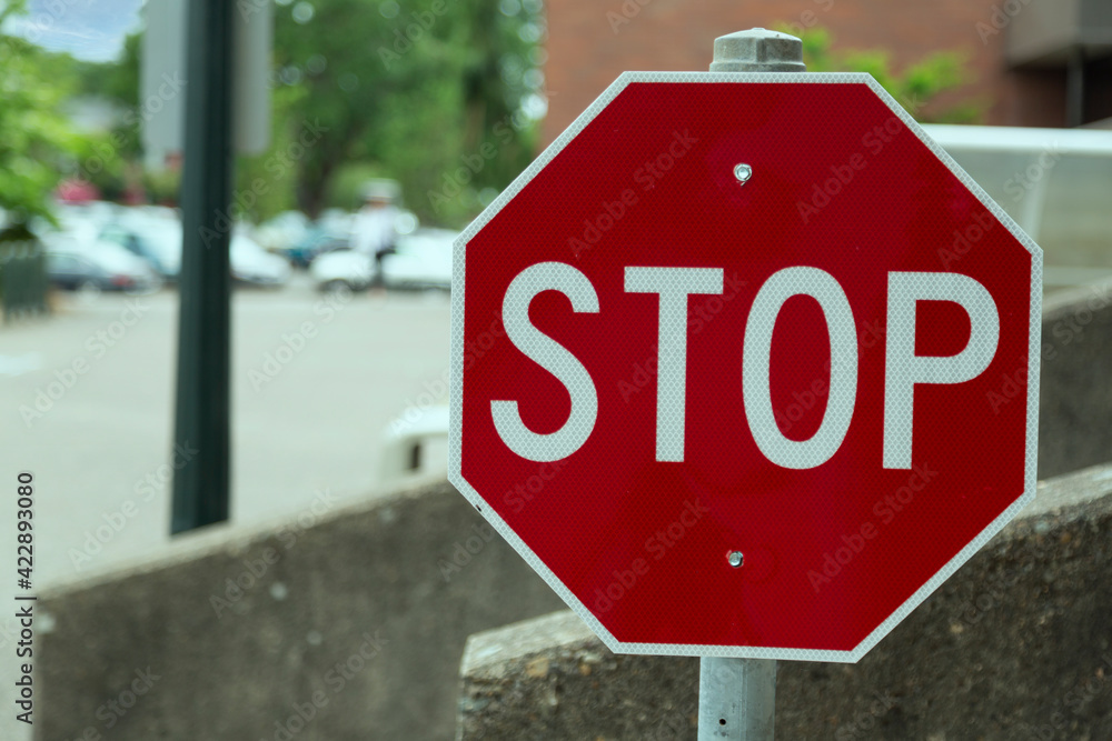 Street stop sign with out of focus cars in the background