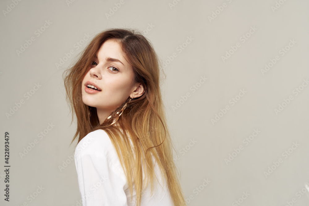 Naklejka premium Attractive woman beautiful hair glamor white shirt fashion student light background