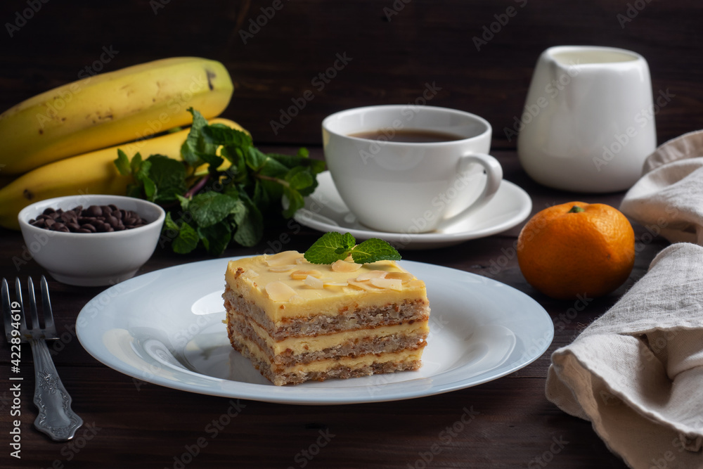 Banana sponge cake with nuts and mint. Delicious sweet dessert for tea, Dark wooden background. Banana sponge cake with nuts and mint. Delicious sweet dessert for tea, Dark wooden background.