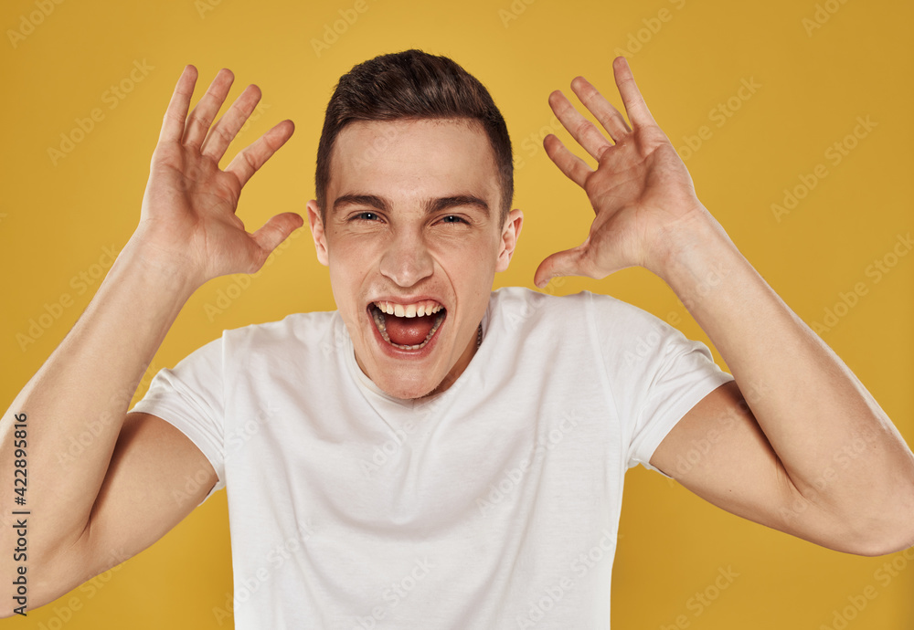 Man laughs on a yellow background Delight emotions joy Man laughs on a yellow background Delight emotions joy