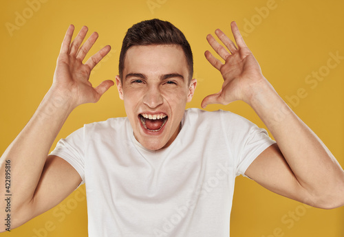 Man laughs on a yellow background Delight emotions joy