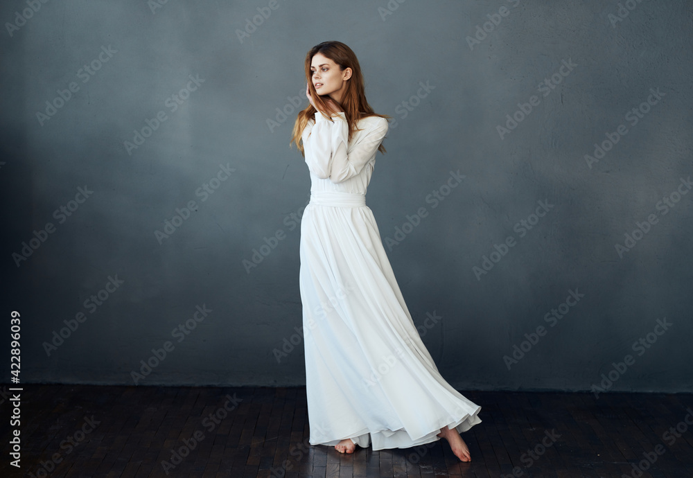 Romantic woman in full growth on a gray background in a white dress Copy Space Romantic woman in full growth on a gray background in a white dress Copy Space