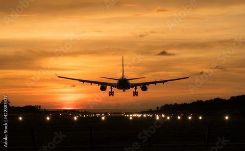 Silhouette Airplane will take-off at an airport during sunset sky