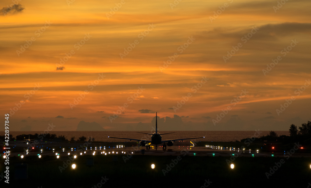 An airplane will take-off at an airport during sunset sky   