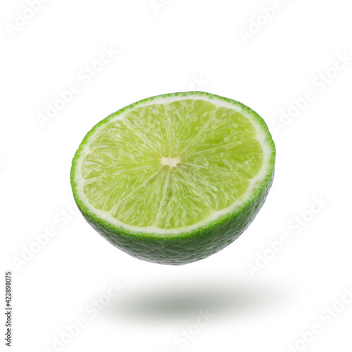 Half with slice of fresh green lime isolated on white background