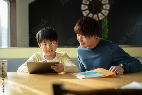 Boy and Tutor Learning with Tablet PC