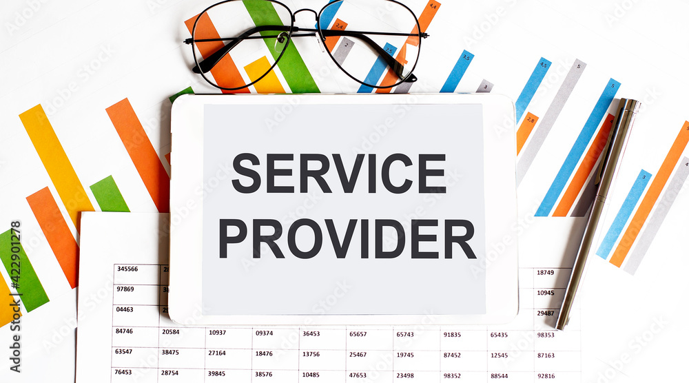 The tablet with tex SERVICE PROVIDER on the business charts and pen,business The tablet with tex SERVICE PROVIDER on the business charts and pen,business