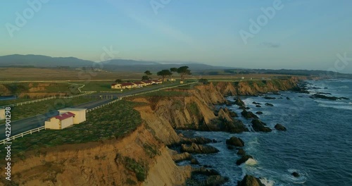 Lighthouse on the pacific coast from above, Point Arena, California coast line, aerial view of ocean waves, cliffs and rocks at Point Arena Mendocino County, United States, sunset windy day