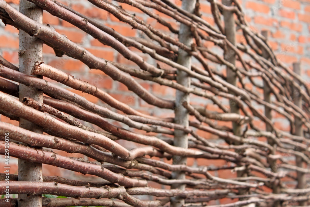 Wooden stylized horizontal fence and red brick wall as a defocused pattern Wooden stylized horizontal fence and red brick wall as a defocused pattern