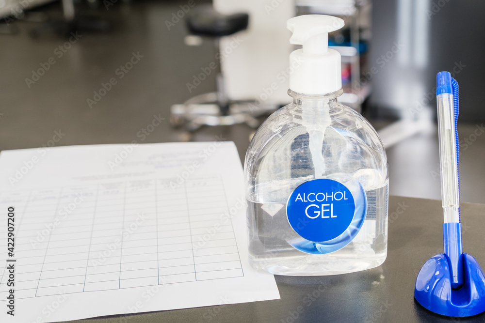 Hand sanitizer at the reception of the salon. Pen and questionnaire for collecting personal information of salon clients. Hand sanitizer at the reception of the salon. Pen and questionnaire for collecting personal information of salon clients.