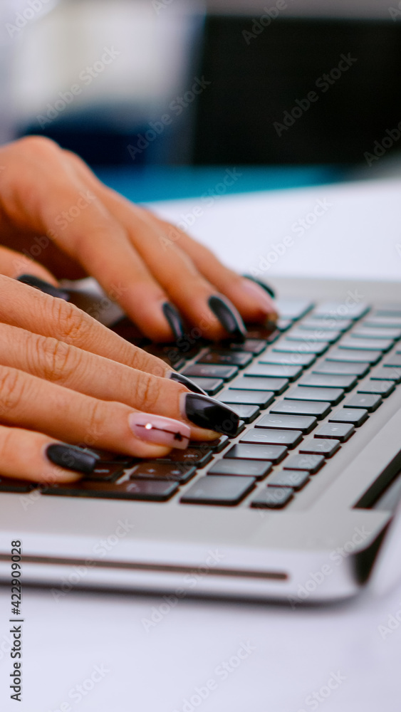 Close up of medical assistant typing patient health report on laptop keyboard making appointments in medical clinic, patient registration. Healthcare physician in medicine uniform writing treatments. Close up of medical assistant typing patient health report on laptop keyboard making appointments in medical clinic, patient registration. Healthcare physician in medicine uniform writing treatments.