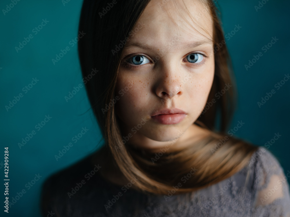 Cute little girl of models on a green background in a gray dress and hairstyle Cute little girl of models on a green background in a gray dress and hairstyle