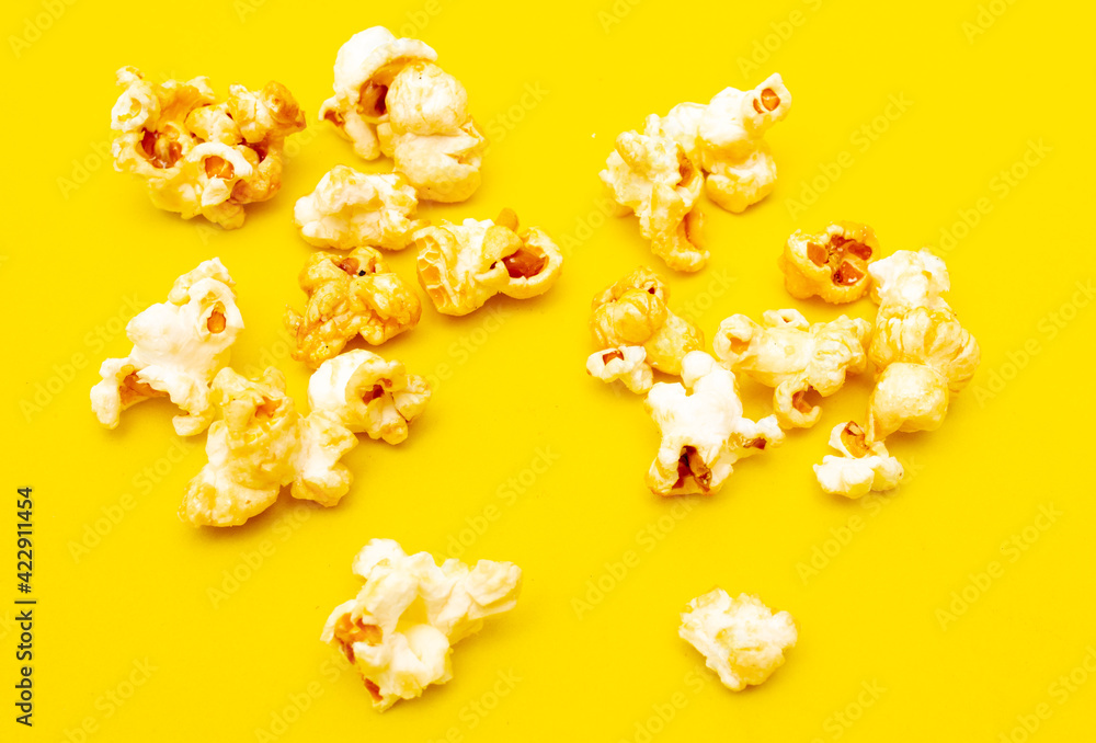 Close-up of popcorn on a yellow background. Close-up of popcorn on a yellow background.