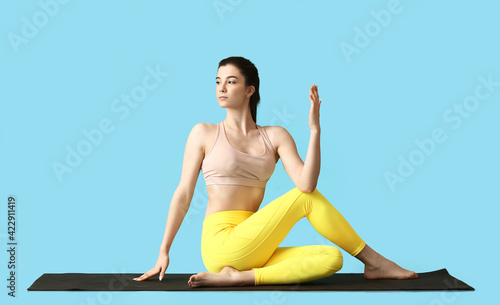 Young woman practicing yoga...