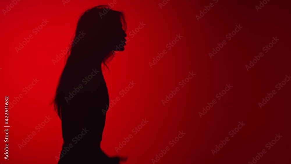 Shadow of angry woman screaming middle finger conflict isolated at red studio. 4k Dragon RED camera Shadow of angry woman screaming middle finger conflict isolated at red studio. 4k Dragon RED camera