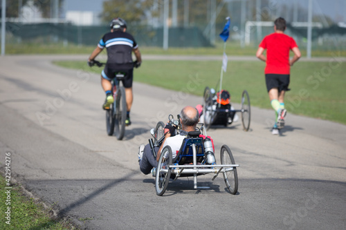 Disabled Athletes training with their Hand Bikes with Cyclist and Runners Close to Them