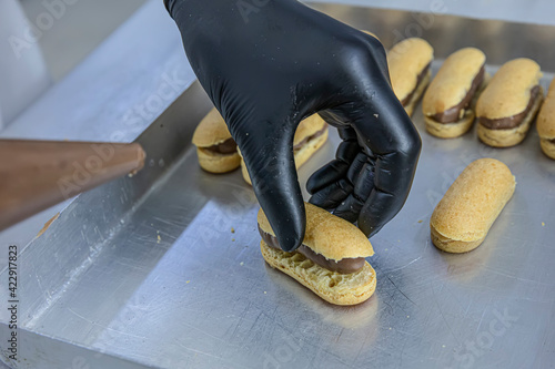 Making chef eclairs in the kitchen. Eclairs Pasta Turkish delicious adds to the platter pasta. photo