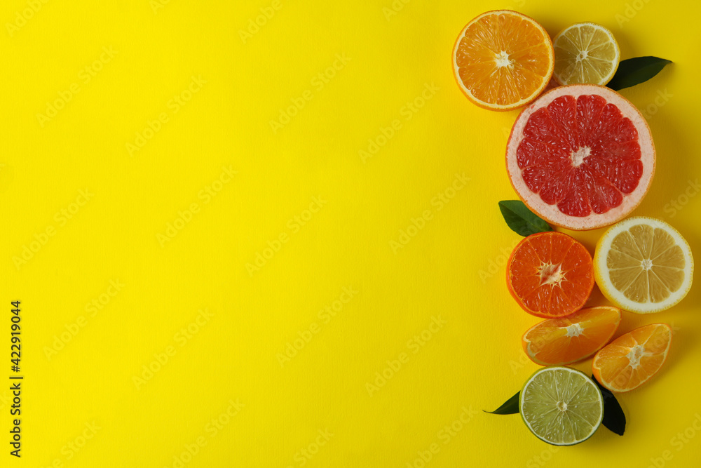 Ripe citrus on yellow background, space for text Ripe citrus on yellow background, space for text