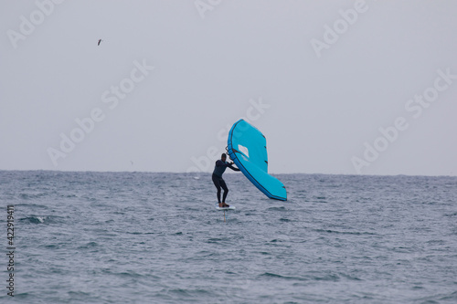 Wing Foiling with a sports action camera, this is a new extreme sport that uses an inflatable wing, and the board rides above the ocean on a hydrofoil that is attached to the board. It is exciting. © Dane