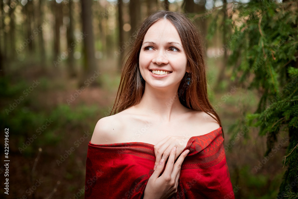 Beautiful young brunette woman with long hair in a forest pines and firs on a summer day Beautiful young brunette woman with long hair in a forest pines and firs on a summer day