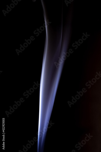 Blue cigarette smoke on a black isolated background