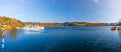 Panorama view over a big lake with hills in the mountain