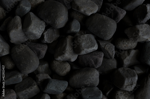 Black stones scattered background. 3d rendering