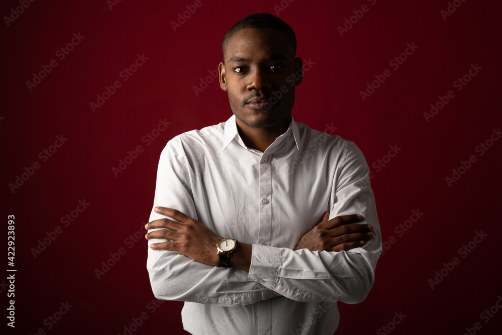 portrait of handsome young african man wearing white shirt 