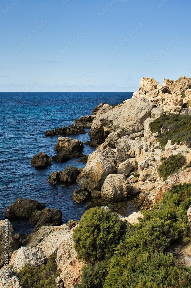 Rocks at Prajjet Bay or Anchor Bay in Popeye Village on a warm fall day in Malta.