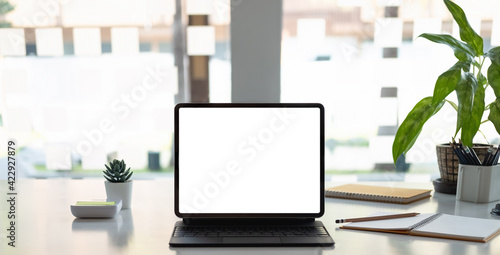 Digital tablet with white blank screen on table. workspace concept.