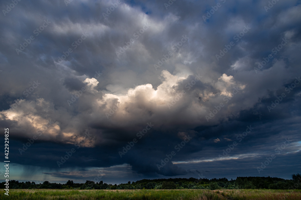 Cumulus clouds in a blue sky.