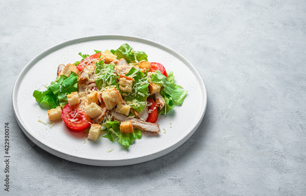 Fresh vegetable salad with chicken breast on a gray background with space to copy. Fresh vegetable salad with chicken breast on a gray background with space to copy.