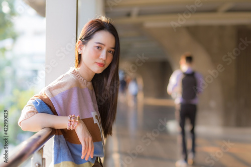Asian beautiful woman in colorful sweater standing to rest from walking in the heat of the city in health care pollution PM2.5 and new normal concept.
