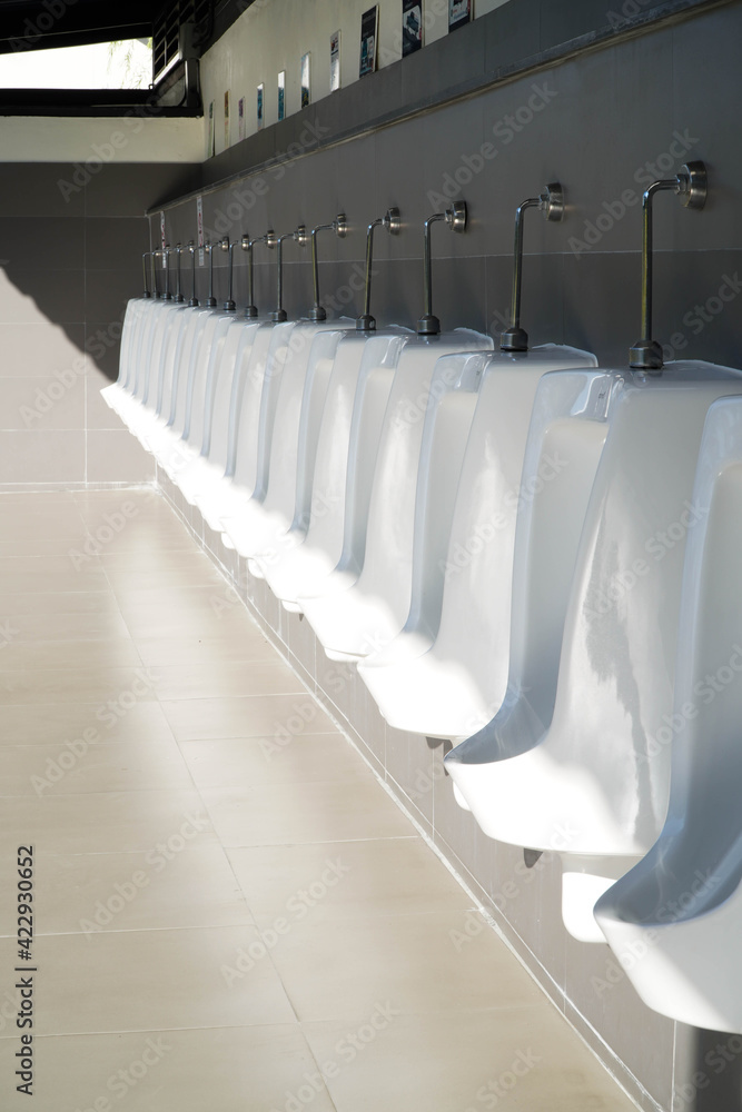 Fototapeta premium Automatic urinals in the men's bathroom,Automatic cleaning system in male toilet.