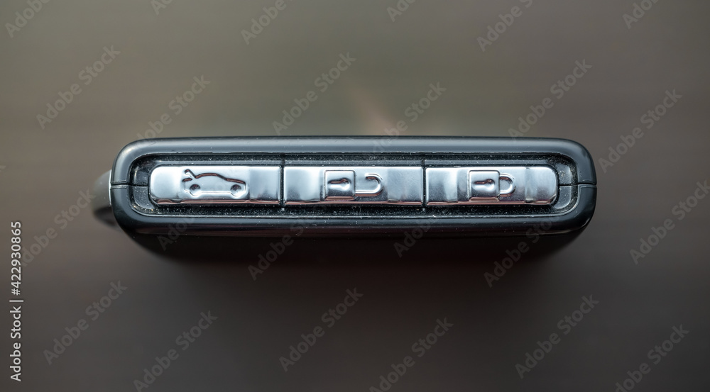 Black key fob remote control on window with natural light Black key fob remote control on window with natural light