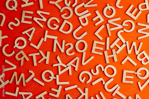 wooden cut alphabet letters on orange background photo