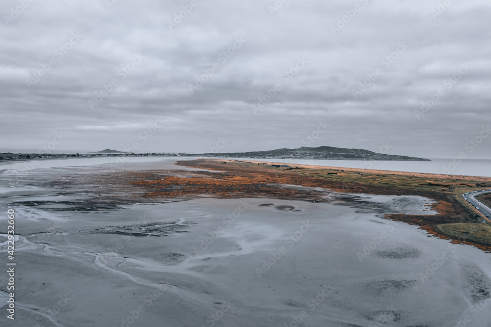 Aerial view over the Bull Island estuary in Dublin and Howth peninsula on the horizon.