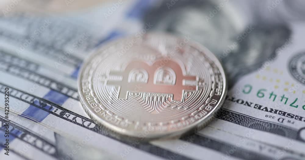 Bitcoin coin lying on dollar bills 4k movie Bitcoin coin lying on dollar bills 4k movie