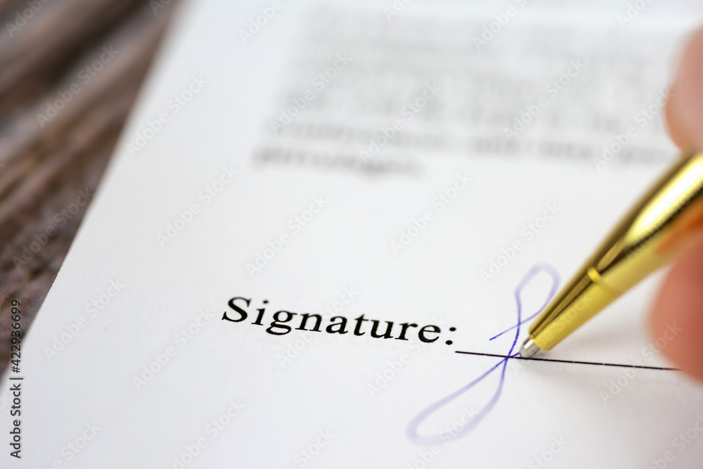 Signing a contract with signature with gold pen macro close-up, businessman,contract,deal,concept background Signing a contract with signature with gold pen macro close-up, businessman,contract,deal,concept background