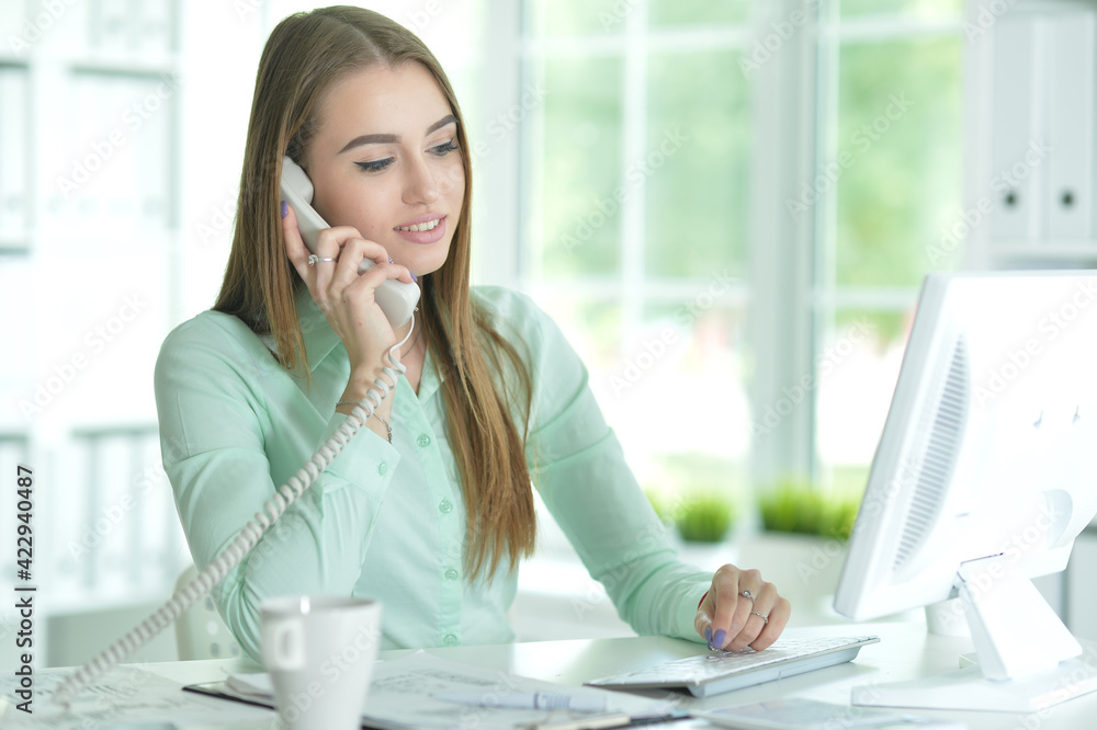 Portrait of businesswoman working in office talking on phone Portrait of businesswoman working in office talking on phone