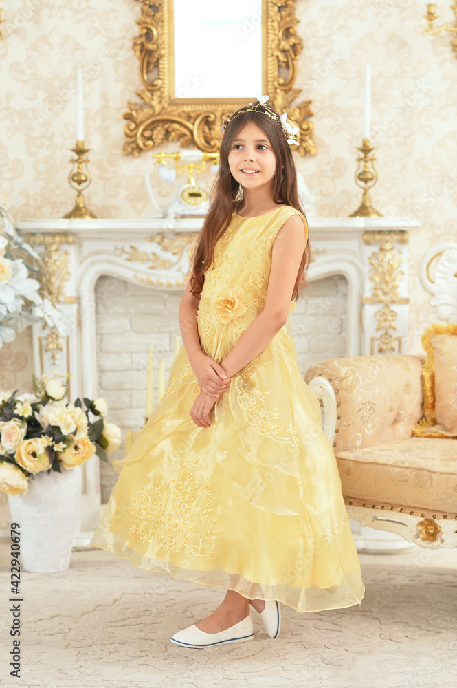 Beautiful girl princess in yellow dress posing in the room Beautiful girl princess in yellow dress posing in the room