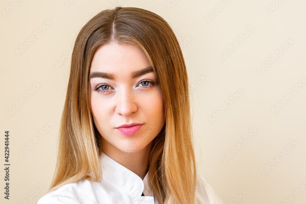 Portrait of beautiful young caucasian businesswoman looking at camera against a light yellow background Portrait of beautiful young caucasian businesswoman looking at camera against a light yellow background