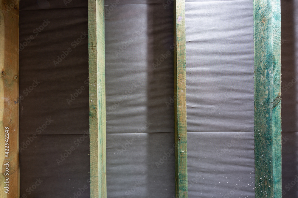Roof beams with an insulating membrane ready to be insulated with mineral wool Roof beams with an insulating membrane ready to be insulated with mineral wool
