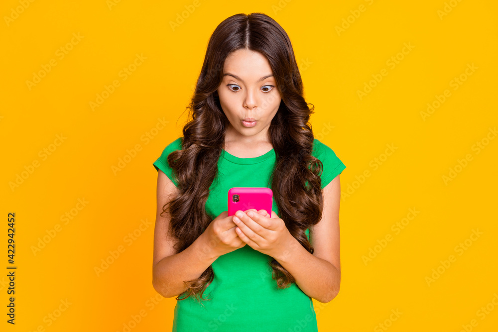 Photo of shocked amazed surprised crazy little girl see negative bad comment dislike isolated on yellow color background Photo of shocked amazed surprised crazy little girl see negative bad comment dislike isolated on yellow color background