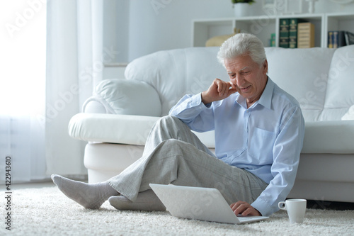 Emotional senior man using laptop at home © aletia2011