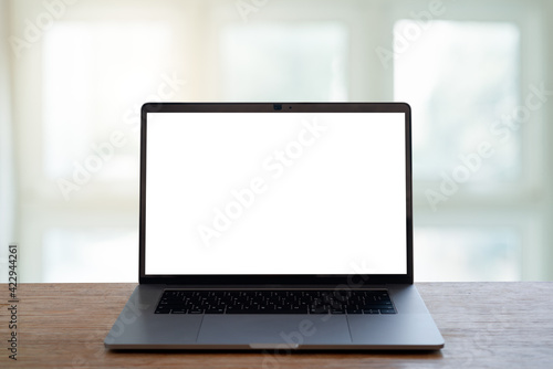 laptop with screen on wooden table.