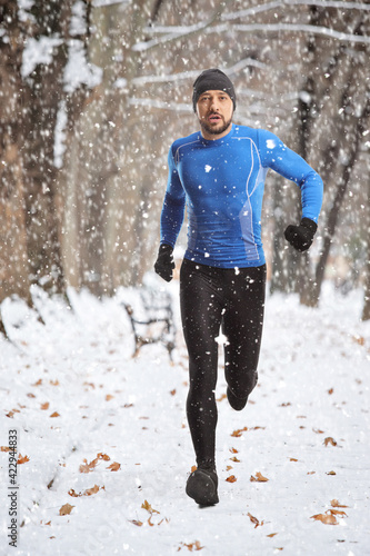 Full length portrait of a fit young man running outdoors © Ljupco Smokovski